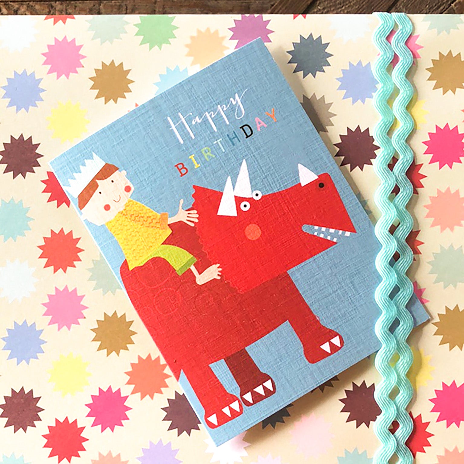 mini boy on a dinosaur birthday card