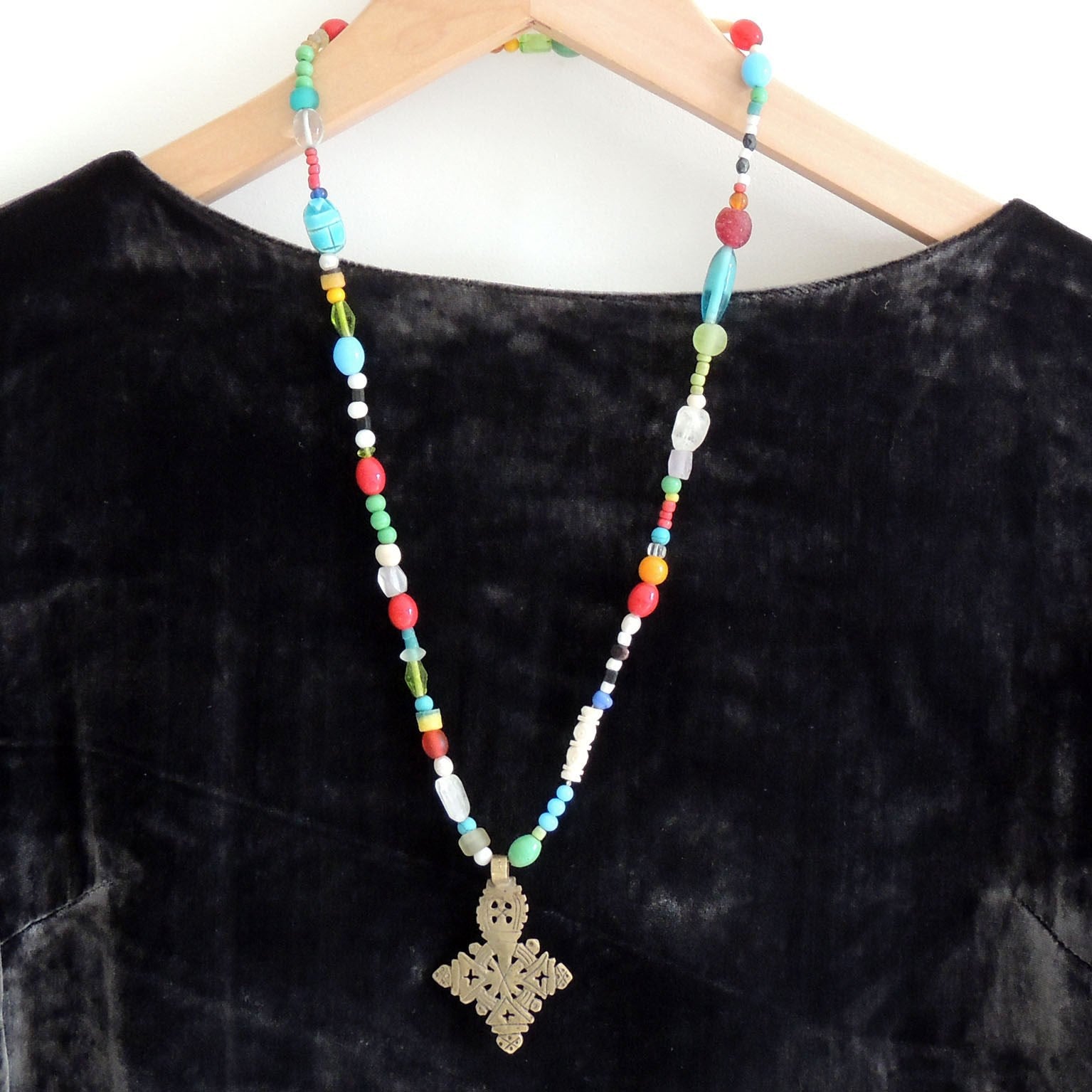 beaded necklace with a silver Ethiopean cross