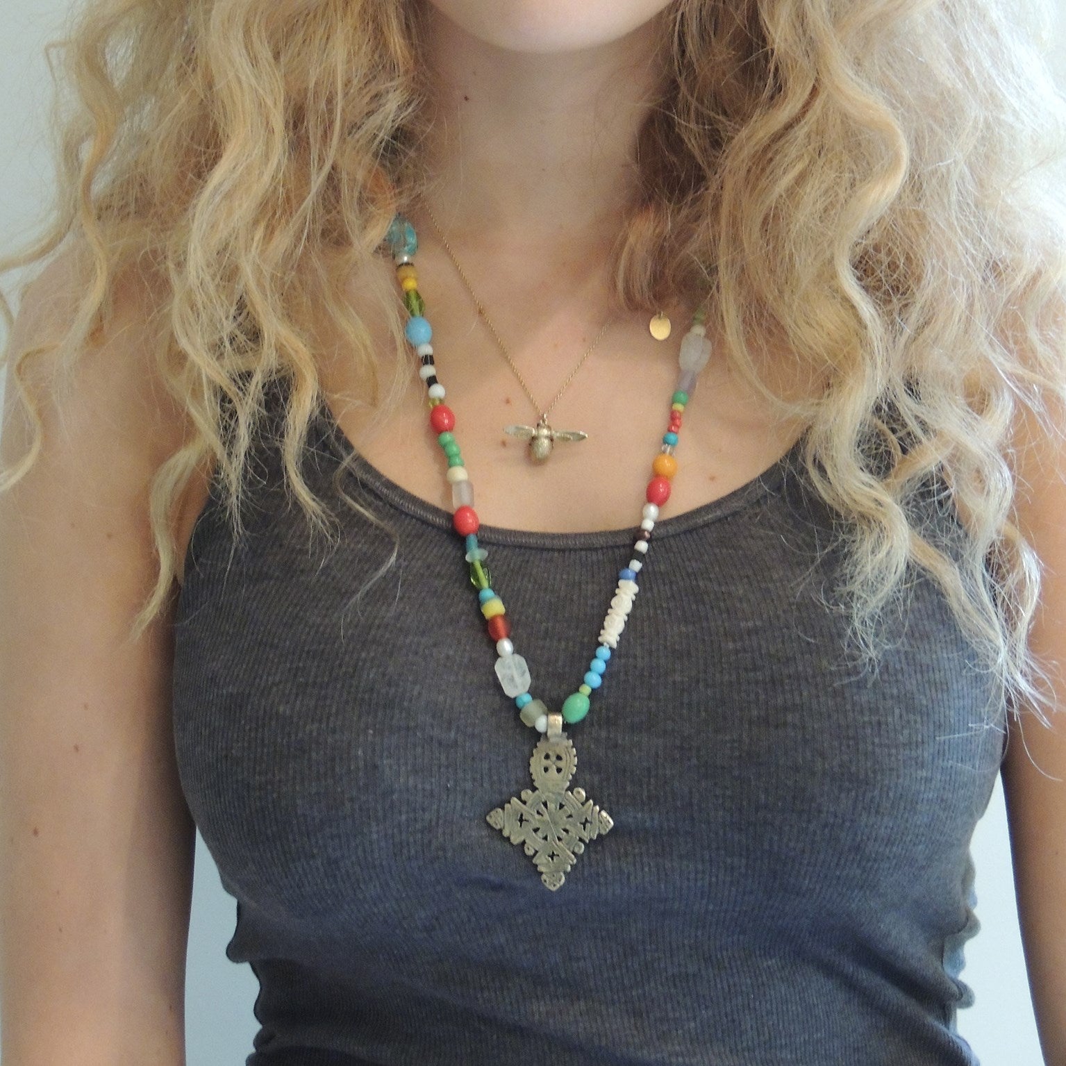 beaded necklace with a silver Ethiopean cross