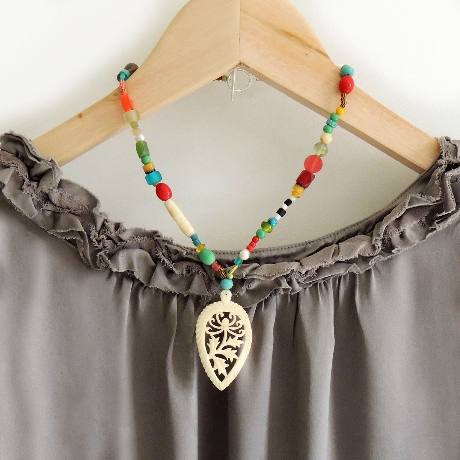 beaded necklace with 1920's carved bone pendant