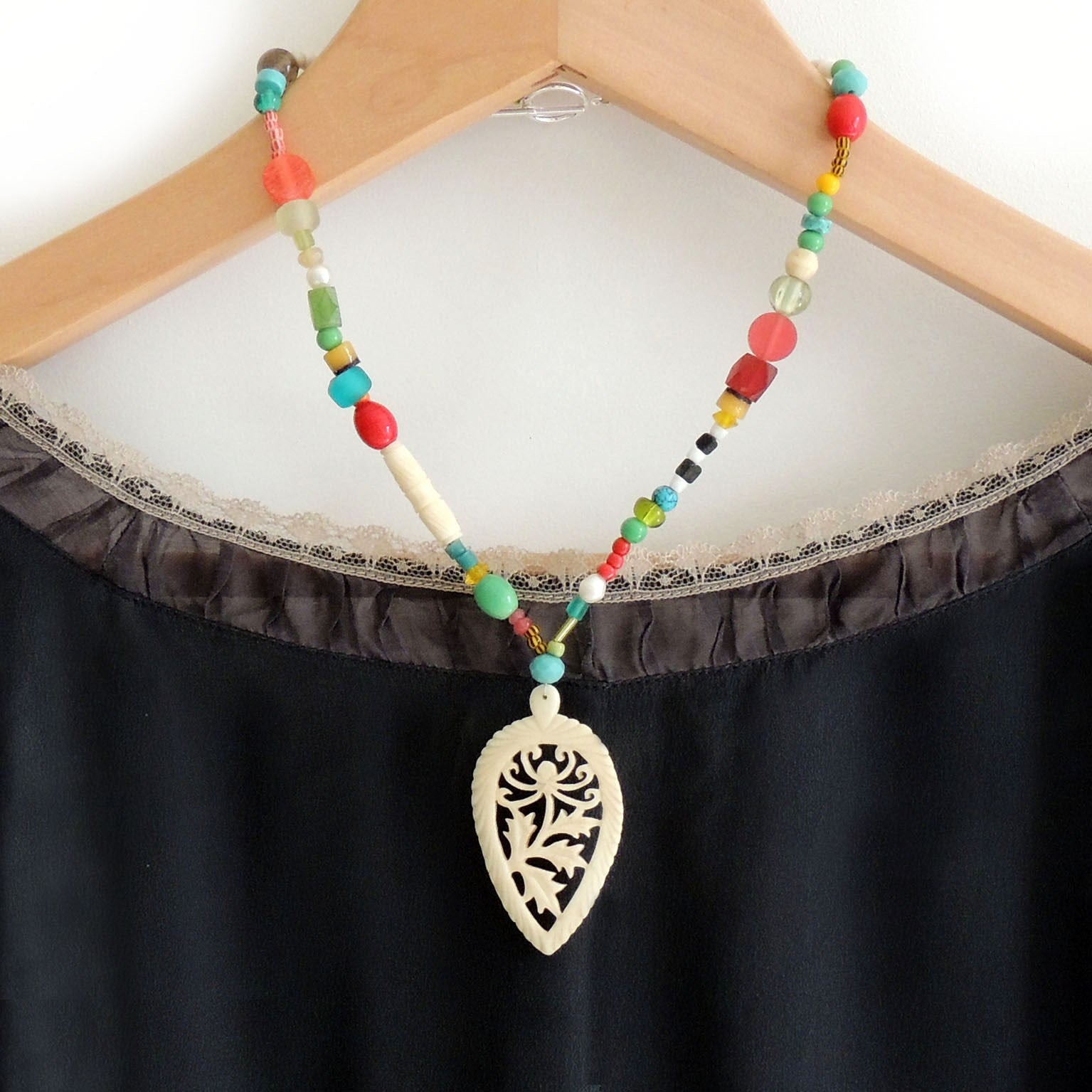 beaded necklace with 1920's carved bone pendant