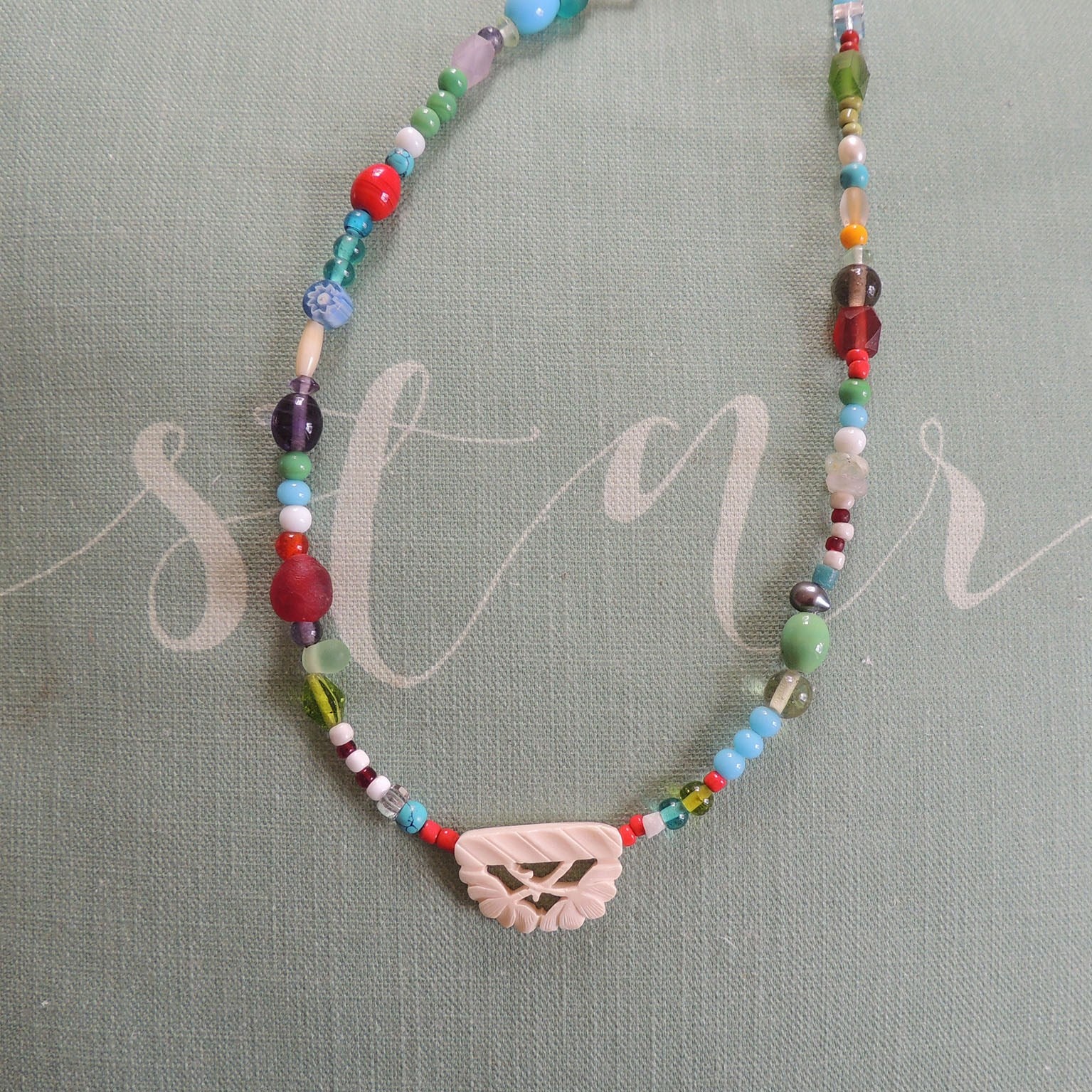 beaded necklace with carved bone bead